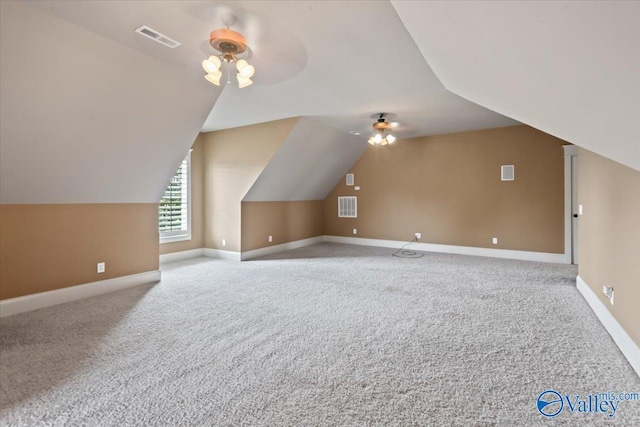 additional living space with vaulted ceiling, light colored carpet, and ceiling fan