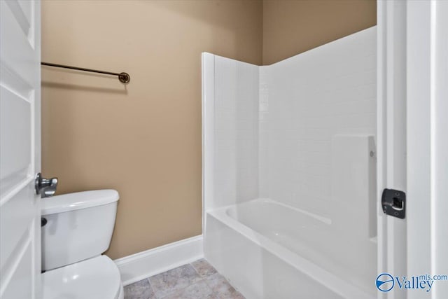 bathroom featuring bathtub / shower combination and toilet