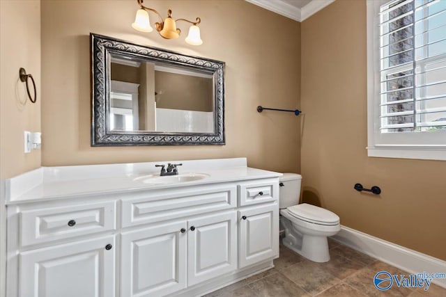 bathroom featuring ornamental molding, vanity, and toilet