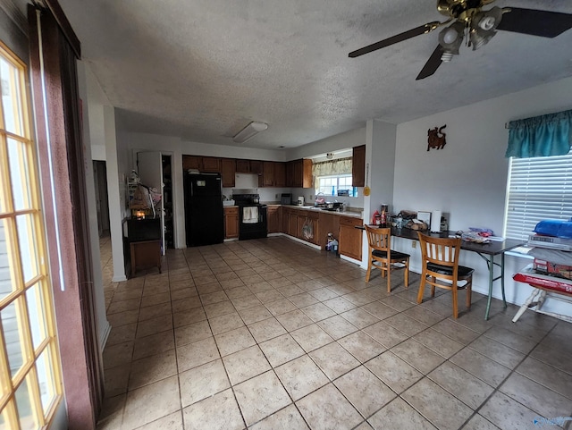 kitchen featuring ceiling fan, light tile patterned floors, a textured ceiling, and black appliances