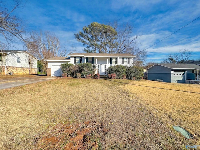 ranch-style home featuring a garage and a front lawn