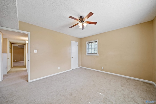 unfurnished bedroom featuring a textured ceiling, carpet flooring, and baseboards