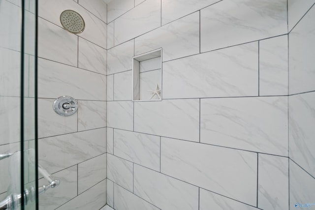 bathroom with a tile shower