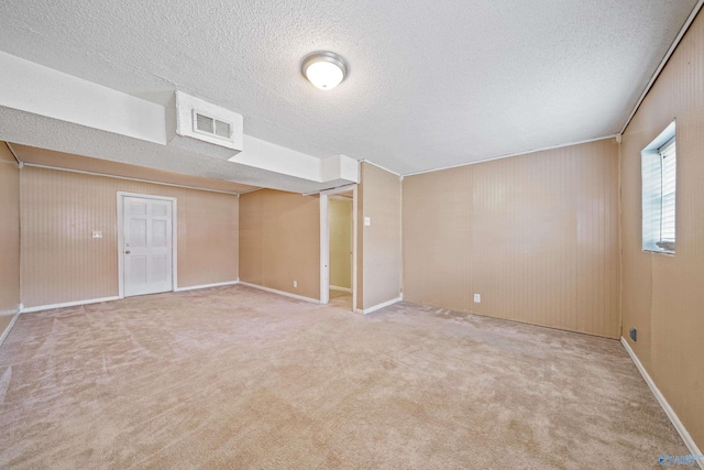 interior space featuring a textured ceiling, carpet, and visible vents