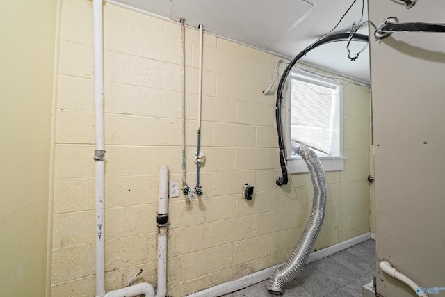 washroom featuring concrete block wall