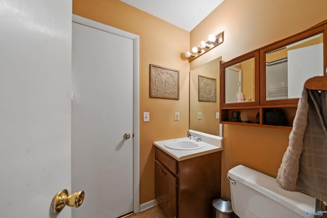 bathroom with tile patterned floors, vanity, and toilet