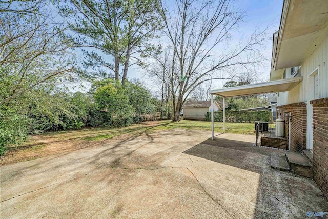 view of yard featuring a patio area and driveway