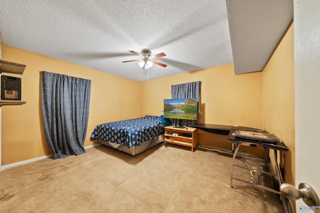 carpeted bedroom featuring a textured ceiling, a ceiling fan, and baseboards