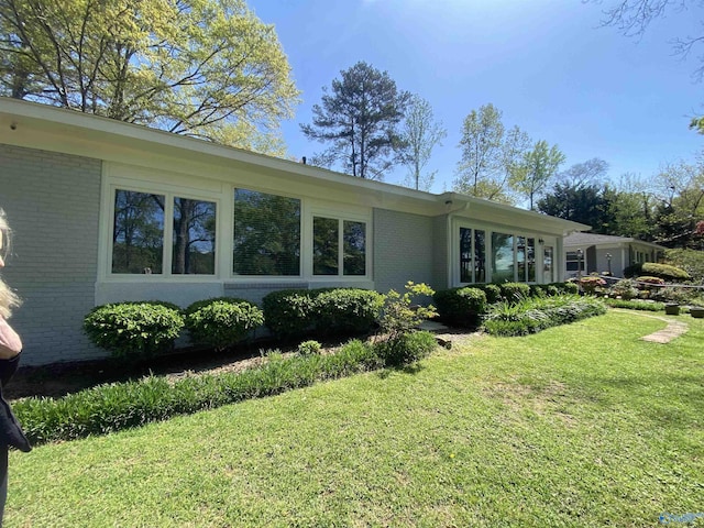 1702 Roseberry Dr, Scottsboro, AL 35769 - rear view of house with a lawn and brick siding