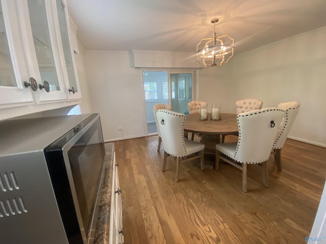1702 Roseberry Dr, Scottsboro, AL 35769 - dining space with baseboards, wood finished floors, an inviting chandelier, and crown molding