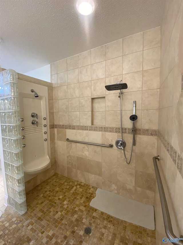 1702 Roseberry Dr, Scottsboro, AL 35769 - bathroom featuring tile patterned floors, a textured ceiling, tile walls, and tiled shower