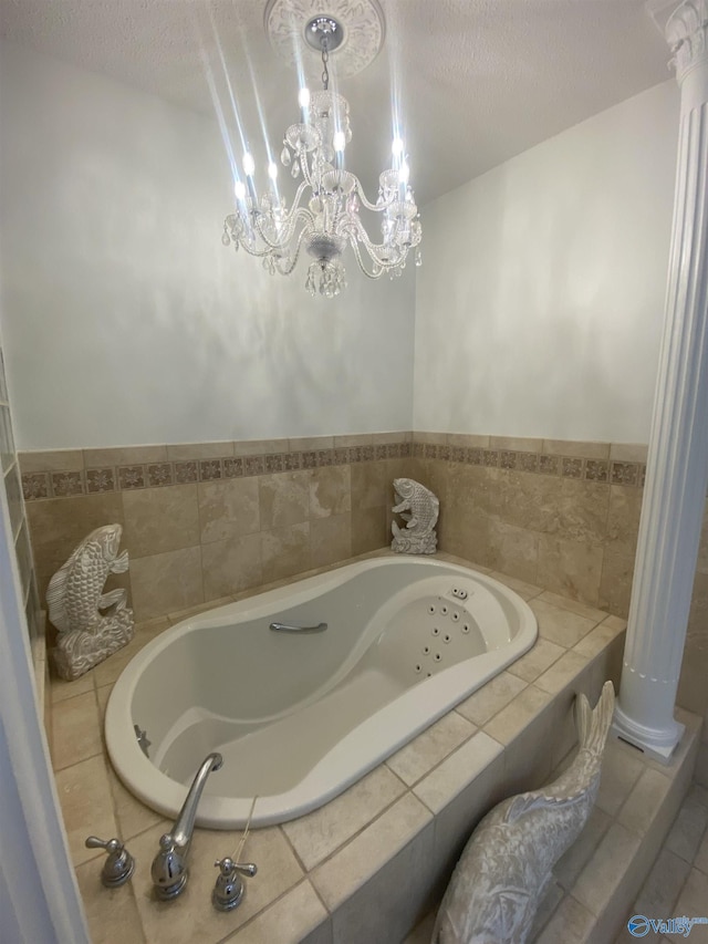 1702 Roseberry Dr, Scottsboro, AL 35769 - full bathroom featuring a textured ceiling, an inviting chandelier, a jetted tub, ornate columns, and tile patterned flooring