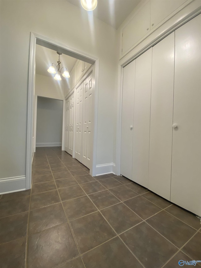 1702 Roseberry Dr, Scottsboro, AL 35769 - corridor featuring baseboards, a chandelier, and dark tile patterned flooring