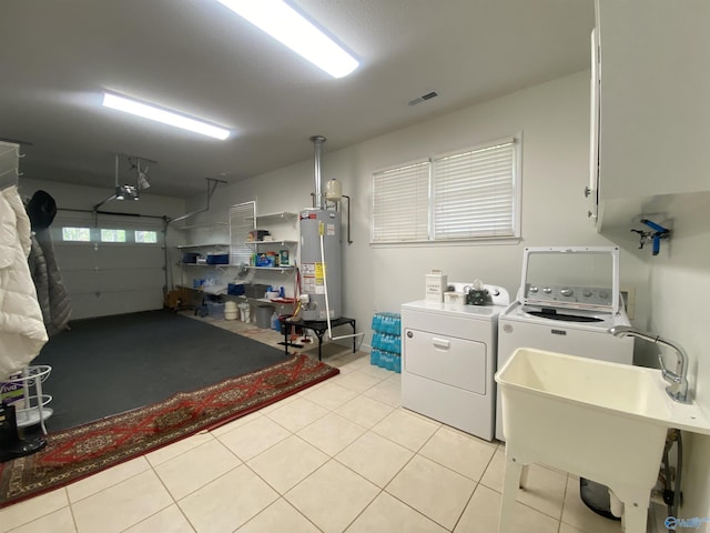 1702 Roseberry Dr, Scottsboro, AL 35769 - washroom featuring a garage, washing machine and dryer, light tile patterned flooring, visible vents, and water heater