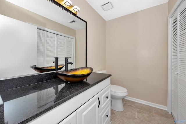 409 Hobbs Rd SE, Huntsville, AL 35803 - bathroom featuring a closet, toilet, vanity, and visible vents