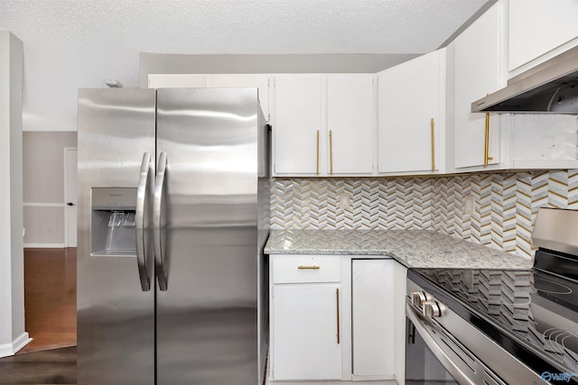 409 Hobbs Rd SE, Huntsville, AL 35803 - kitchen with backsplash, under cabinet range hood, white cabinets, and stainless steel appliances