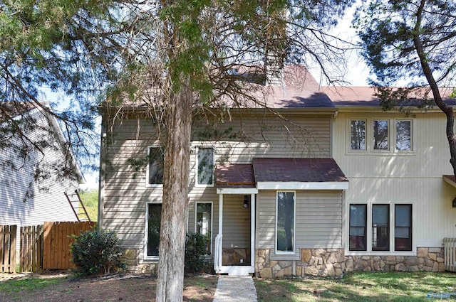 409 Hobbs Rd SE, Huntsville, AL 35803 - view of front of house with roof with shingles, stone siding, and fence