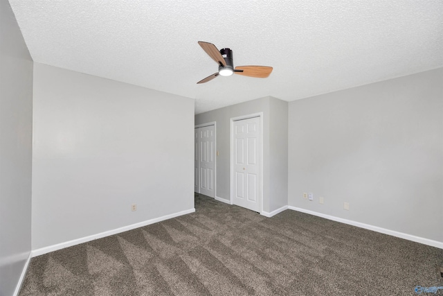 409 Hobbs Rd SE, Huntsville, AL 35803 - unfurnished bedroom with carpet flooring, a textured ceiling, baseboards, a ceiling fan, and two closets