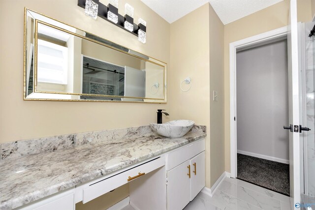 409 Hobbs Rd SE, Huntsville, AL 35803 - full bath featuring baseboards, walk in shower, marble finish floor, and vanity