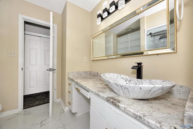 409 Hobbs Rd SE, Huntsville, AL 35803 - bathroom with marble finish floor, baseboards, and vanity