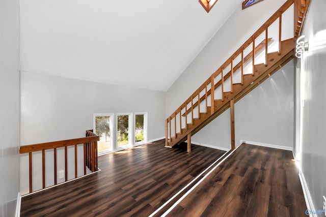 409 Hobbs Rd SE, Huntsville, AL 35803 - stairway featuring baseboards, wood finished floors, and high vaulted ceiling