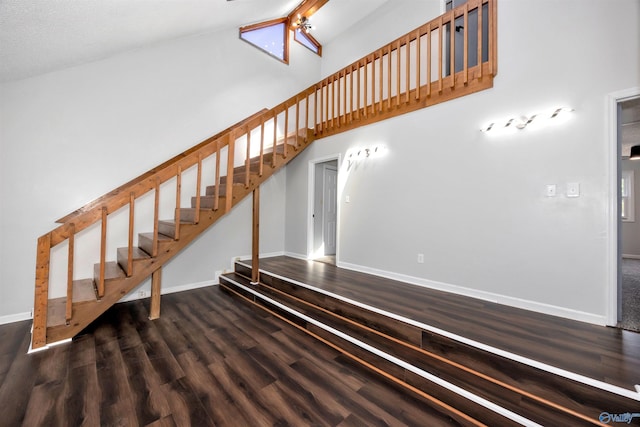 409 Hobbs Rd SE, Huntsville, AL 35803 - stairway with high vaulted ceiling, wood finished floors, and baseboards