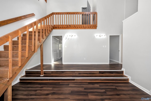 409 Hobbs Rd SE, Huntsville, AL 35803 - stairway with wood finished floors, a towering ceiling, and baseboards