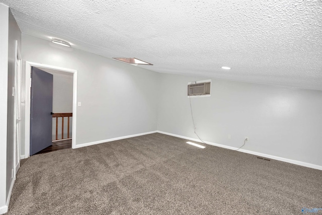 409 Hobbs Rd SE, Huntsville, AL 35803 - basement featuring a wall mounted AC, baseboards, carpet floors, and a textured ceiling