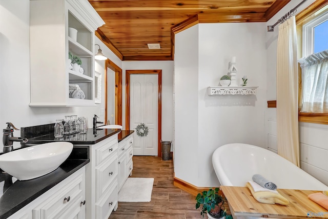 bathroom with a bathtub, wood ceiling, vanity, and hardwood / wood-style floors