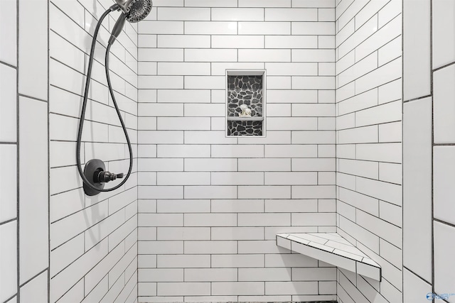 bathroom with a tile shower