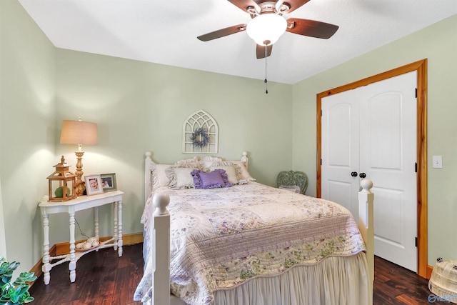 bedroom with ceiling fan, a closet, and dark hardwood / wood-style flooring