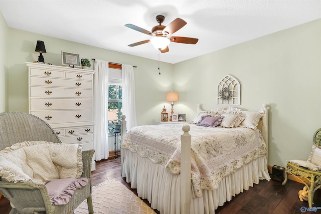 bedroom with ceiling fan and dark wood-type flooring