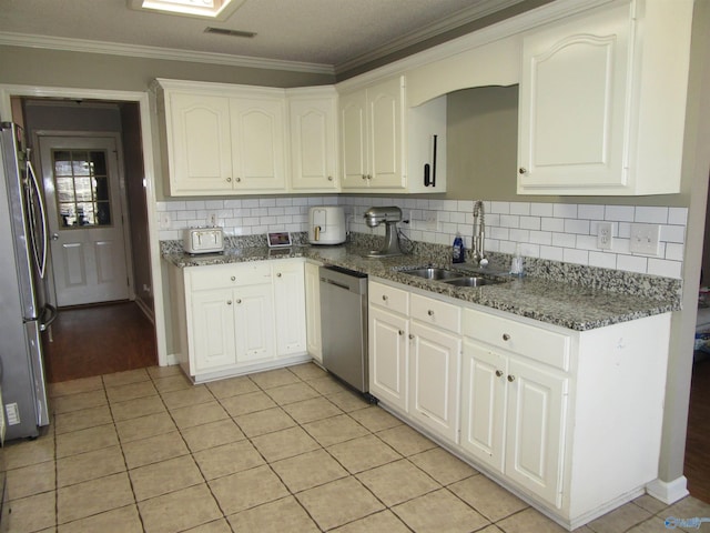 kitchen with stainless steel appliances, a sink, white cabinetry, visible vents, and crown molding