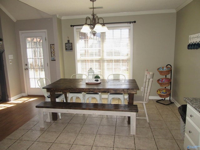 dining room featuring crown molding, a notable chandelier, and plenty of natural light