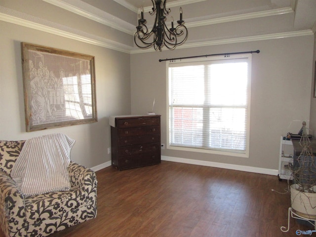 sitting room with a raised ceiling, a notable chandelier, crown molding, and wood finished floors