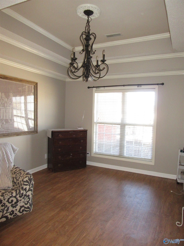 unfurnished room with dark wood-style floors, a raised ceiling, visible vents, and a notable chandelier