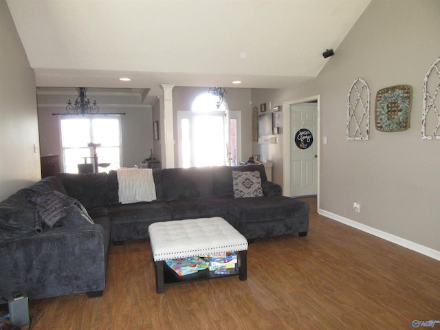 living room featuring lofted ceiling, baseboards, wood finished floors, and recessed lighting