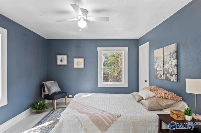 bedroom featuring a ceiling fan and baseboards