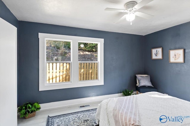 bedroom featuring visible vents, baseboards, and ceiling fan