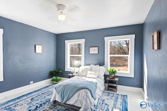 bedroom featuring a ceiling fan and baseboards