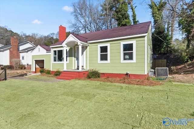 view of front of property with an attached garage, crawl space, a chimney, and a front yard