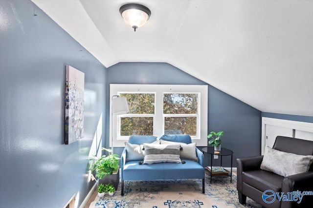 sitting room featuring vaulted ceiling