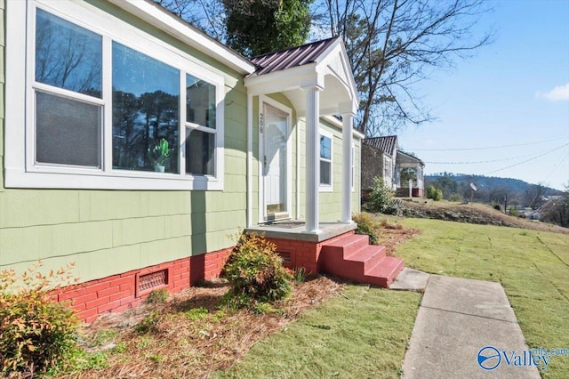 view of property exterior with metal roof, a yard, and crawl space