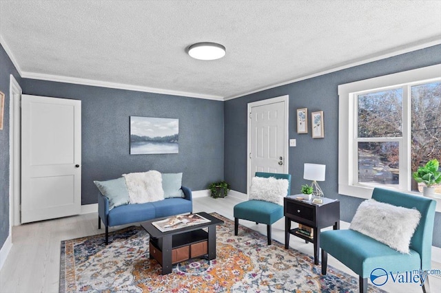 living room featuring ornamental molding, wood finished floors, and baseboards