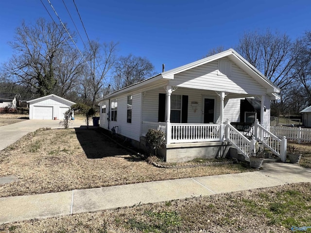 view of front of home with a porch, an outbuilding, and a detached garage