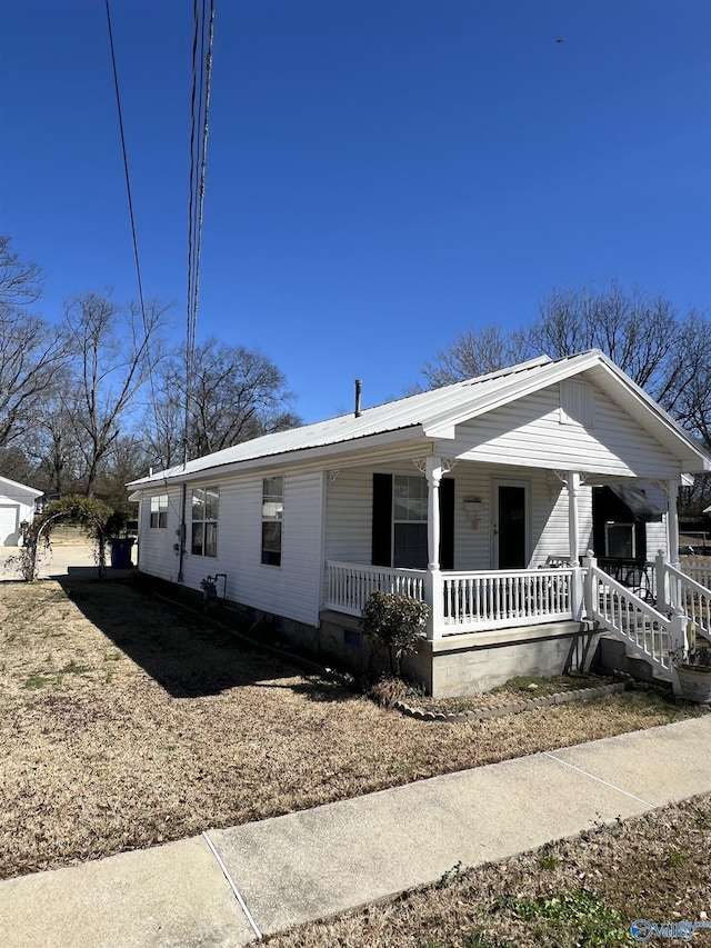 view of front of home featuring metal roof and a porch