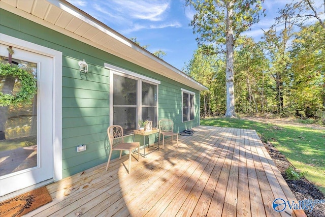 wooden terrace with a yard