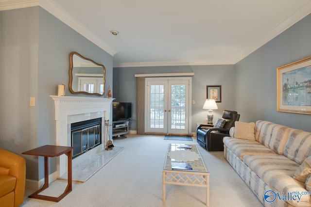 carpeted living room with a premium fireplace, crown molding, and french doors