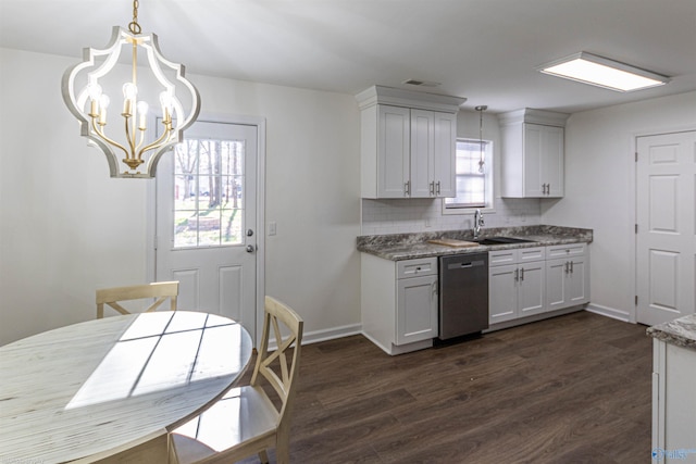 kitchen with a notable chandelier, tasteful backsplash, dark hardwood / wood-style flooring, stainless steel dishwasher, and sink