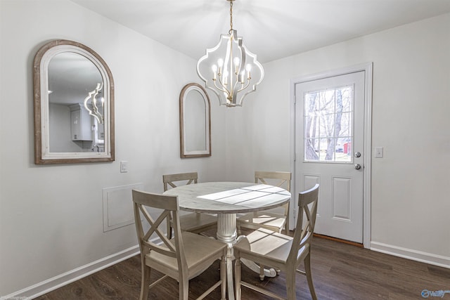 dining space featuring a notable chandelier and dark hardwood / wood-style flooring